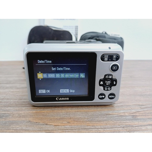 34 - Two cased Canon PowerShot CCD sensor compact digital cameras, one A1400 16mp with instruction manual... 