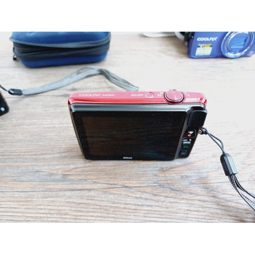 Three Nikon Coolpix 16mp compact digital cameras, one cased S6300 BSI ...
