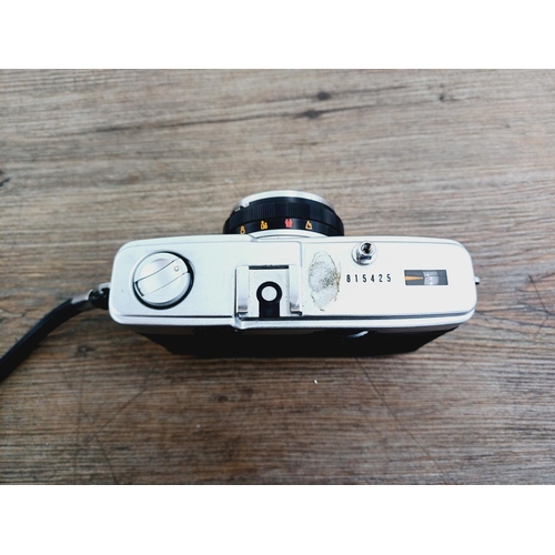 22 - A leather cased Olympus Trip 35 fully-automatic compact 35mm camera with wrist strap