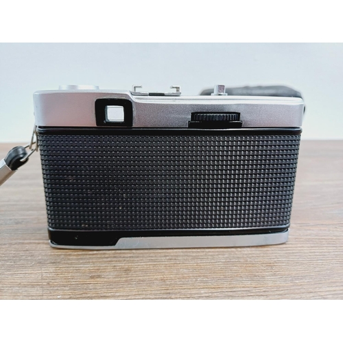 22 - A leather cased Olympus Trip 35 fully-automatic compact 35mm camera with wrist strap