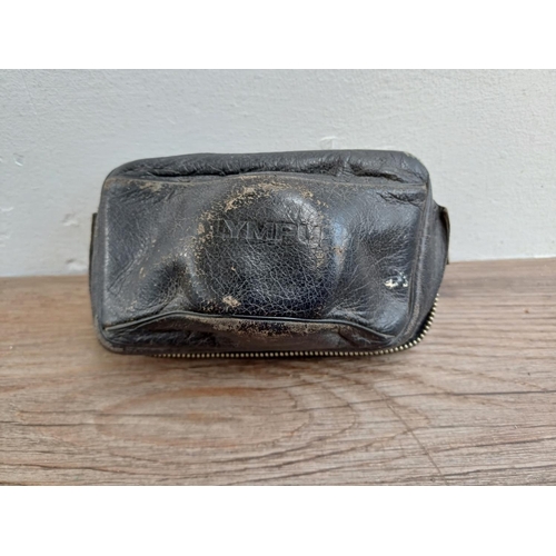 22 - A leather cased Olympus Trip 35 fully-automatic compact 35mm camera with wrist strap