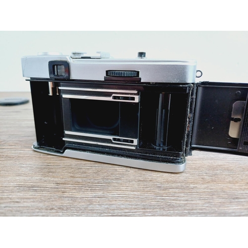 24 - Two Olympus Trip 35 fully-automatic compact 35mm cameras, one with lens cap