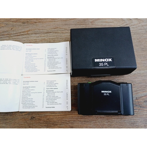 26 - A cased Minox 35 PL ultra-compact 35mm camera with instruction manual