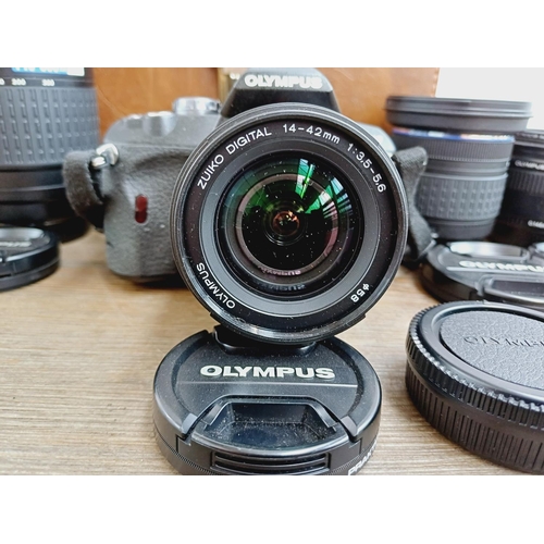 13 - A cased Olympus E-410 10mp Four Thirds CMOS sensor DSLR camera fitted with Zuiko Digital ED 1:3.5-5.... 