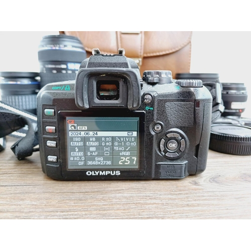 13 - A cased Olympus E-410 10mp Four Thirds CMOS sensor DSLR camera fitted with Zuiko Digital ED 1:3.5-5.... 