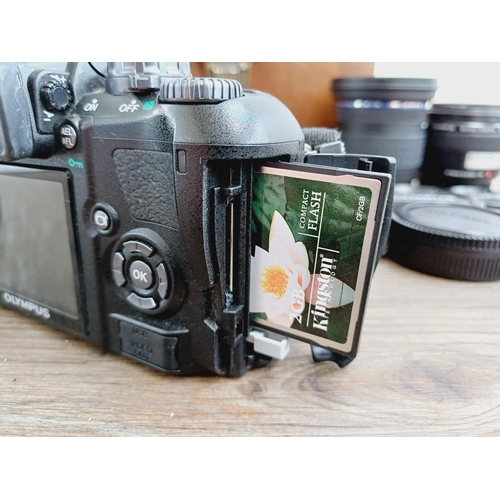 13 - A cased Olympus E-410 10mp Four Thirds CMOS sensor DSLR camera fitted with Zuiko Digital ED 1:3.5-5.... 