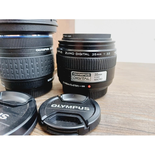 13 - A cased Olympus E-410 10mp Four Thirds CMOS sensor DSLR camera fitted with Zuiko Digital ED 1:3.5-5.... 