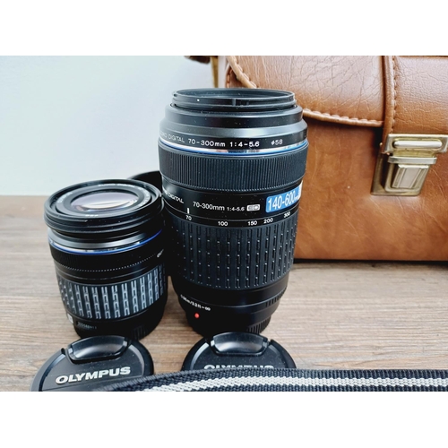 13 - A cased Olympus E-410 10mp Four Thirds CMOS sensor DSLR camera fitted with Zuiko Digital ED 1:3.5-5.... 