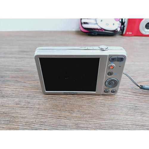 17 - Two Olympus 14mp compact digital cameras, one X-44 and one VG-120 with Hello Kitty case