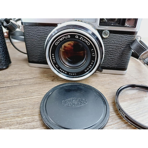 21 - Two cased 35mm cameras, one Olympus 35 SP spot and centre-weighted metering rangefinder fitted with ... 