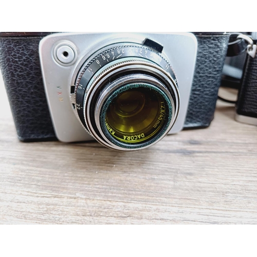 21 - Two cased 35mm cameras, one Olympus 35 SP spot and centre-weighted metering rangefinder fitted with ... 