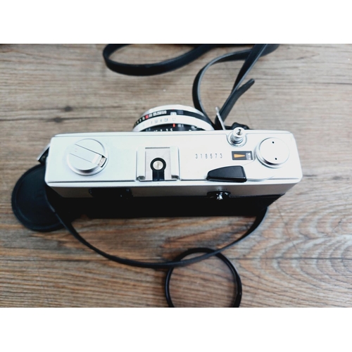 21 - Two cased 35mm cameras, one Olympus 35 SP spot and centre-weighted metering rangefinder fitted with ... 