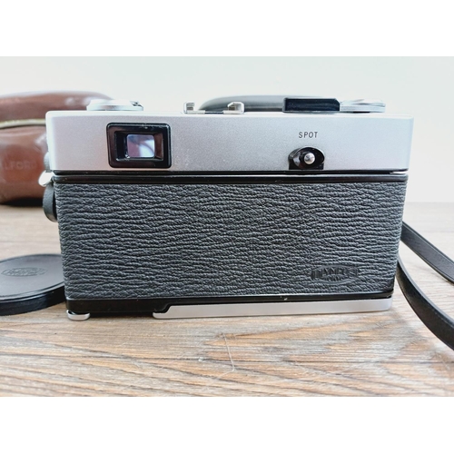 21 - Two cased 35mm cameras, one Olympus 35 SP spot and centre-weighted metering rangefinder fitted with ... 