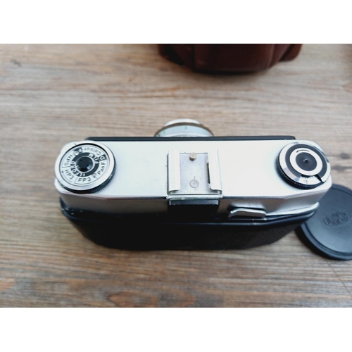 21 - Two cased 35mm cameras, one Olympus 35 SP spot and centre-weighted metering rangefinder fitted with ... 