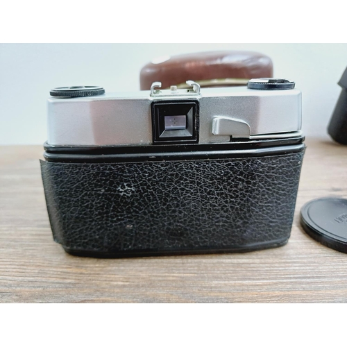 21 - Two cased 35mm cameras, one Olympus 35 SP spot and centre-weighted metering rangefinder fitted with ... 