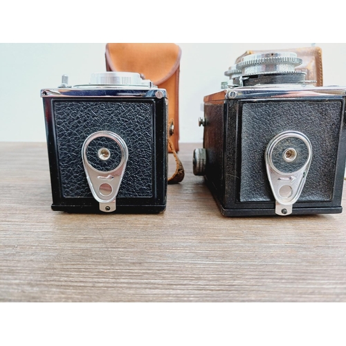 48 - Two cased Haking Halina cameras for 6x6 images on 120 film, one A1 TLR fitted with 1:3.5 80mm lenses... 