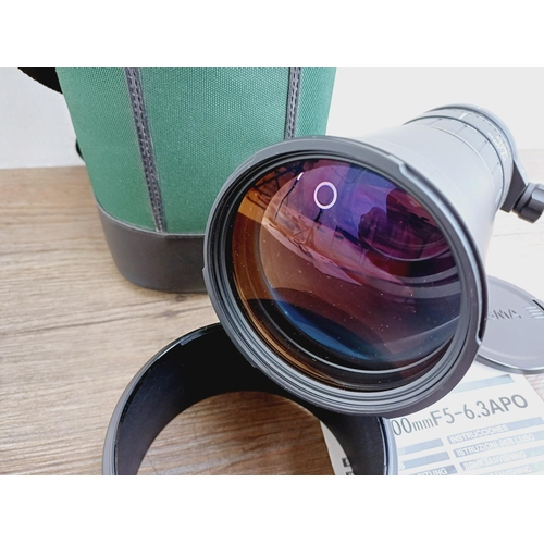 58 - A cased Sigma 1:5-6.3 170-500mm AF/MF APO Canon AF mount lens with Hoya UV filter, caps, shade and i... 