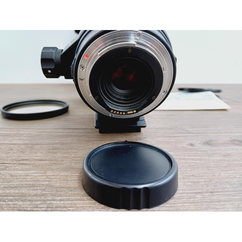 58 - A cased Sigma 1:5-6.3 170-500mm AF/MF APO Canon AF mount lens with Hoya UV filter, caps, shade and i... 