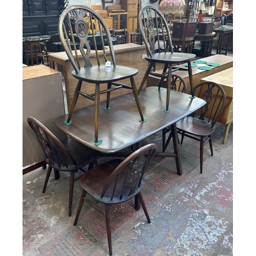 1149 - A mid 20th century Ercol Old Colonial elm and beech dining table and six Ercol Fleur-De-Lys dining c... 