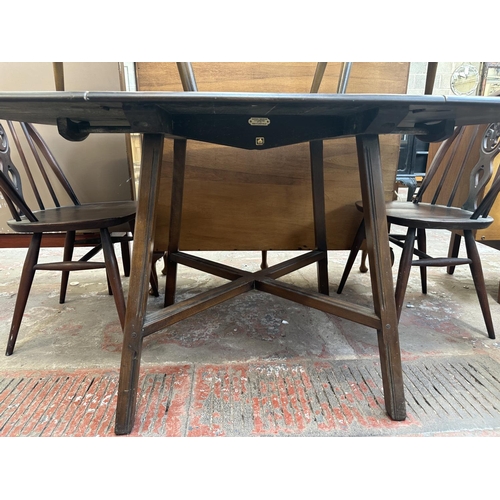 1149 - A mid 20th century Ercol Old Colonial elm and beech dining table and six Ercol Fleur-De-Lys dining c... 