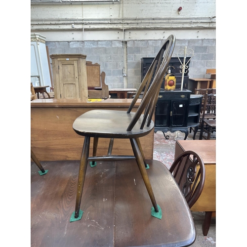 1149 - A mid 20th century Ercol Old Colonial elm and beech dining table and six Ercol Fleur-De-Lys dining c... 