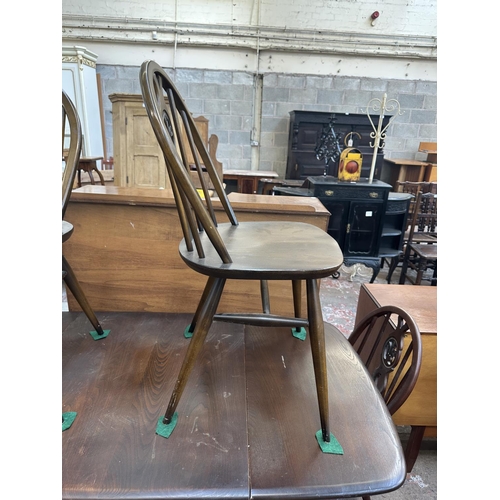 1149 - A mid 20th century Ercol Old Colonial elm and beech dining table and six Ercol Fleur-De-Lys dining c... 