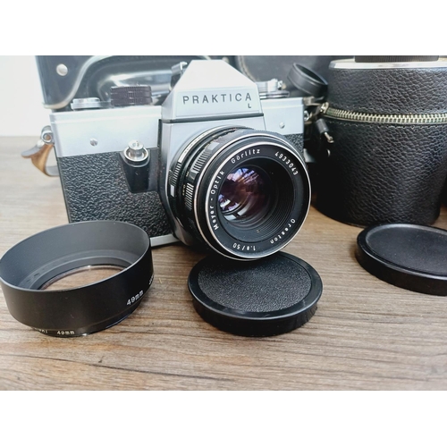 37 - A camera bag containing two Pentacon Praktica M42-mount 35mm SLR cameras, one L fitted with Meyer-Op... 