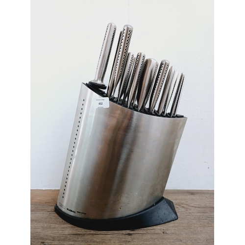 452 - A Yoshikin Global knife block containing fourteen knives and one sharpener