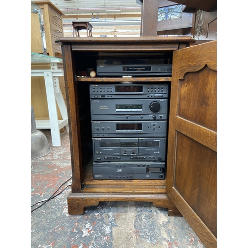 111 - A Titchmarsh & Goodwin style oak stereo cabinet containing Sony five piece stereo system and Matsui ... 