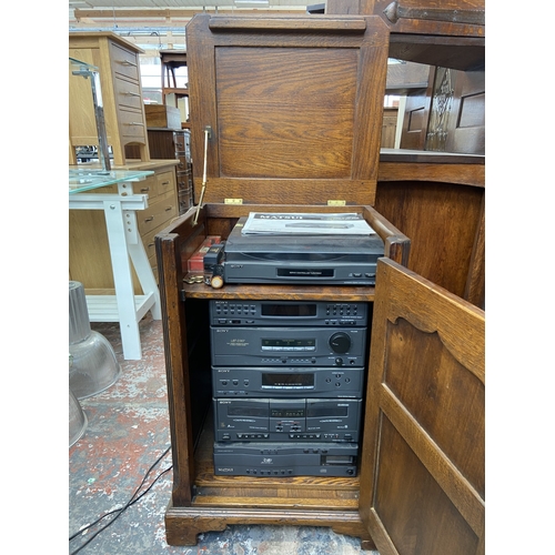 111 - A Titchmarsh & Goodwin style oak stereo cabinet containing Sony five piece stereo system and Matsui ... 