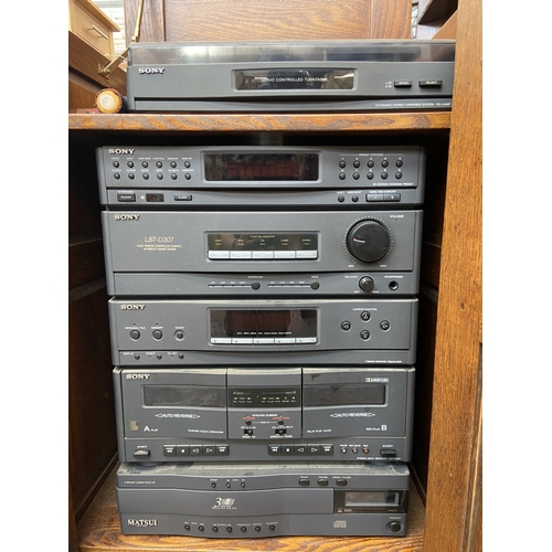 111 - A Titchmarsh & Goodwin style oak stereo cabinet containing Sony five piece stereo system and Matsui ... 