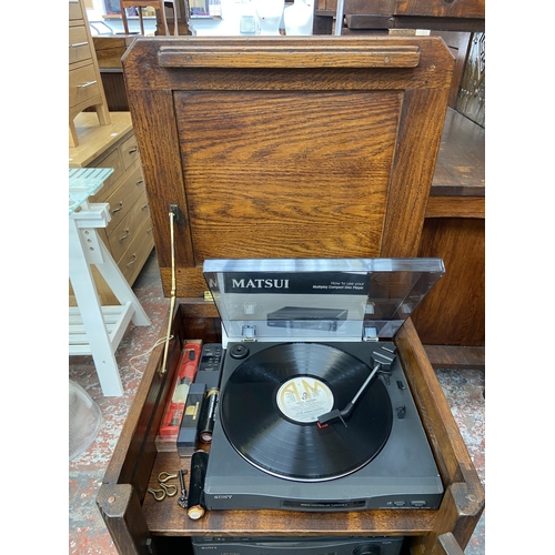 111 - A Titchmarsh & Goodwin style oak stereo cabinet containing Sony five piece stereo system and Matsui ... 