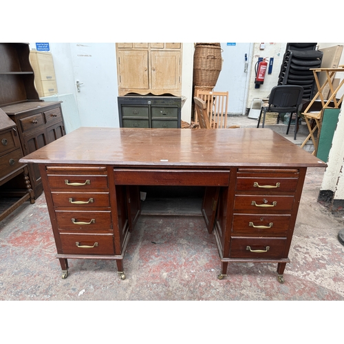 1218 - An Edwardian mahogany pedestal desk on brass castors - approx. 76cm high x 153cm wide x 83cm deep