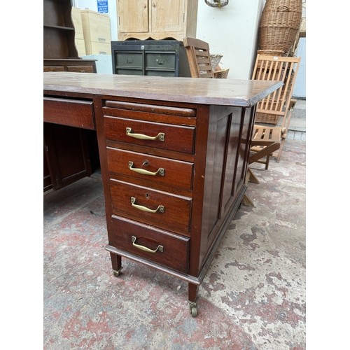 1218 - An Edwardian mahogany pedestal desk on brass castors - approx. 76cm high x 153cm wide x 83cm deep