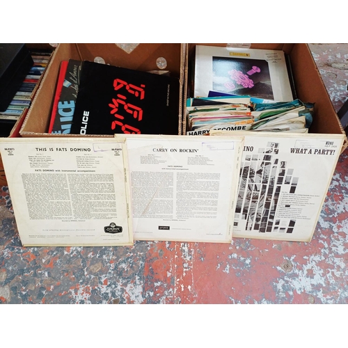 Three boxes, one containing compact cassettes, one containing VHS ...