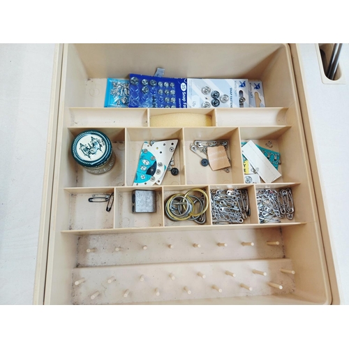 A sewing machine table containing Singer 514 electric sewing machine ...