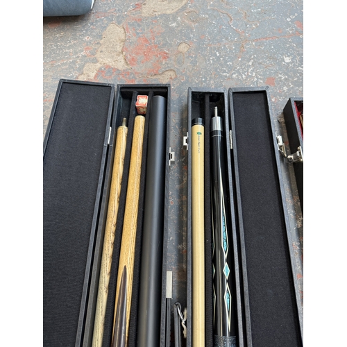 Three cased pool cues to include Waslin, Kruger etc.