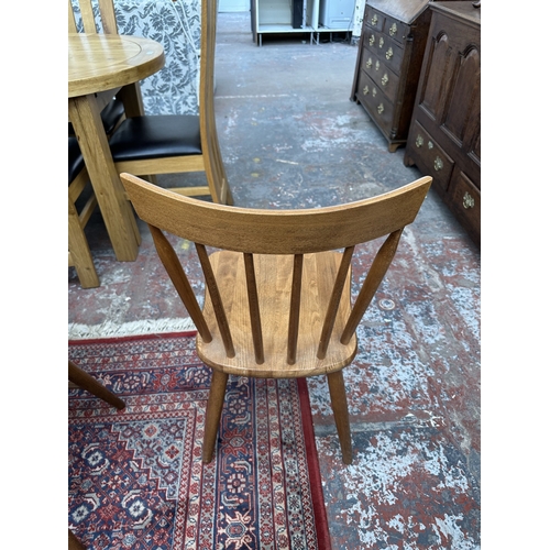 42 - A 1970s Reynolds of Ludlow walnut dining table and eight Ercol style beech spindle back dining chair... 