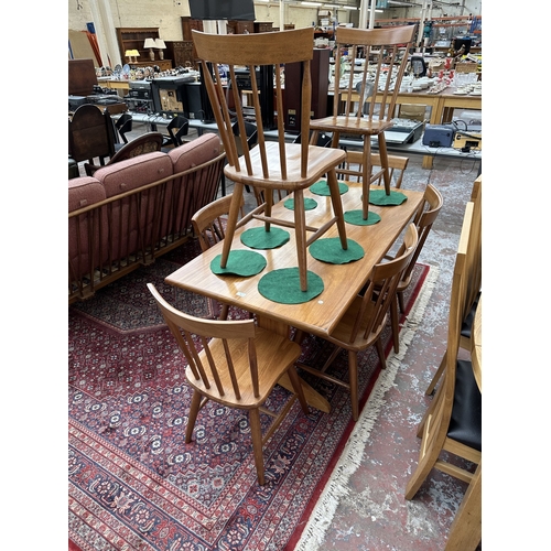 42 - A 1970s Reynolds of Ludlow walnut dining table and eight Ercol style beech spindle back dining chair... 