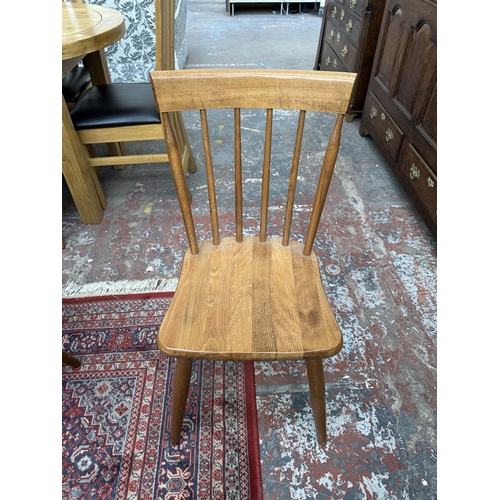 42 - A 1970s Reynolds of Ludlow walnut dining table and eight Ercol style beech spindle back dining chair... 