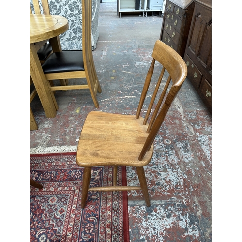 42 - A 1970s Reynolds of Ludlow walnut dining table and eight Ercol style beech spindle back dining chair... 