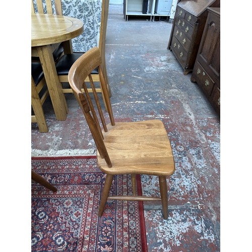 42 - A 1970s Reynolds of Ludlow walnut dining table and eight Ercol style beech spindle back dining chair... 