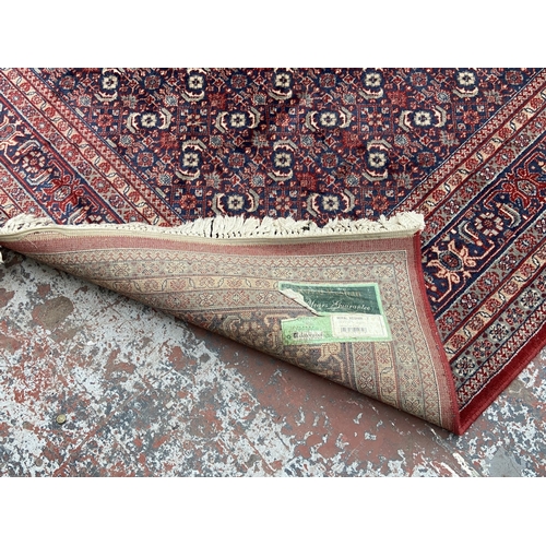 48A - A Hand Made Carpets Ltd Royal Keshan red ground rug - approx. 380cm x 273cm