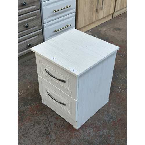 1007 - A modern white laminate bedside chest of drawers - approx. 50cm high x 40cm wide x 40cm deep
