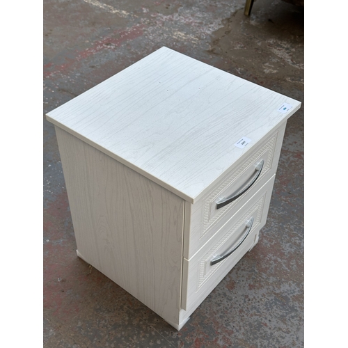 1007 - A modern white laminate bedside chest of drawers - approx. 50cm high x 40cm wide x 40cm deep