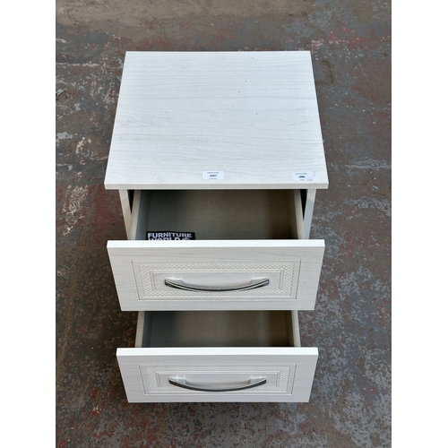 1007 - A modern white laminate bedside chest of drawers - approx. 50cm high x 40cm wide x 40cm deep