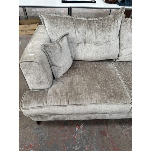 1016 - A modern silver fabric upholstered three seater sofa on hardwood supports - approx. 78cm high x 200c... 