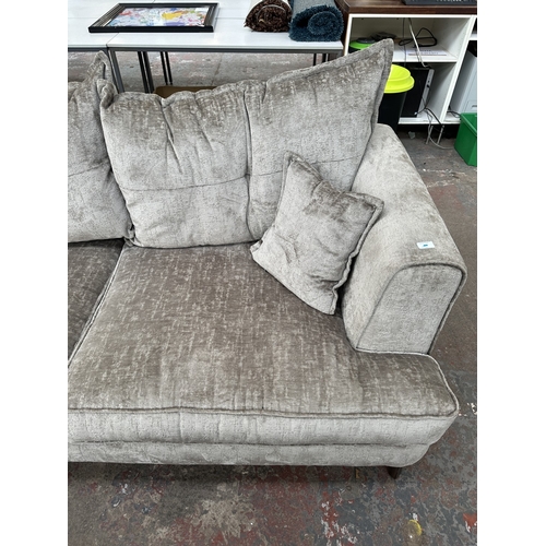1016 - A modern silver fabric upholstered three seater sofa on hardwood supports - approx. 78cm high x 200c... 