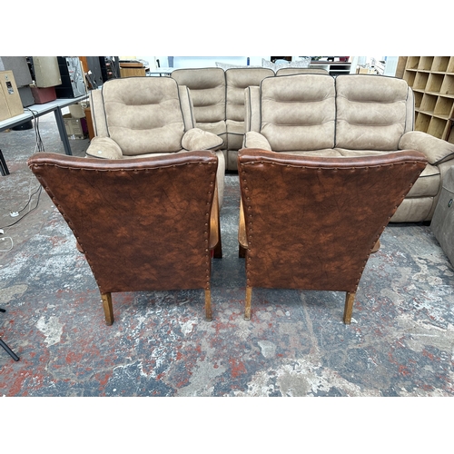 1021 - A pair of mid 20th century beech bentwood armchairs with tan vinyl upholstered backs and red fabric ... 