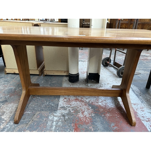 1024 - A 1970s Reynolds of Ludlow walnut dining table - approx. 73cm high x 76cm wide x 151cm long